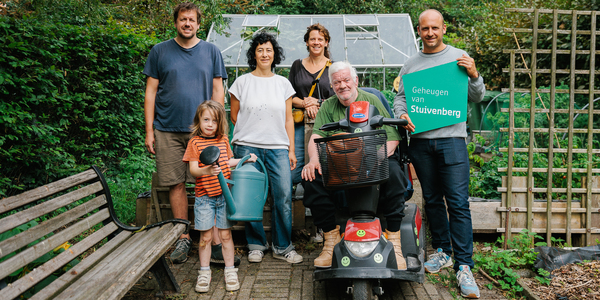 5 volwassenen en 1 kind staan in een tuin