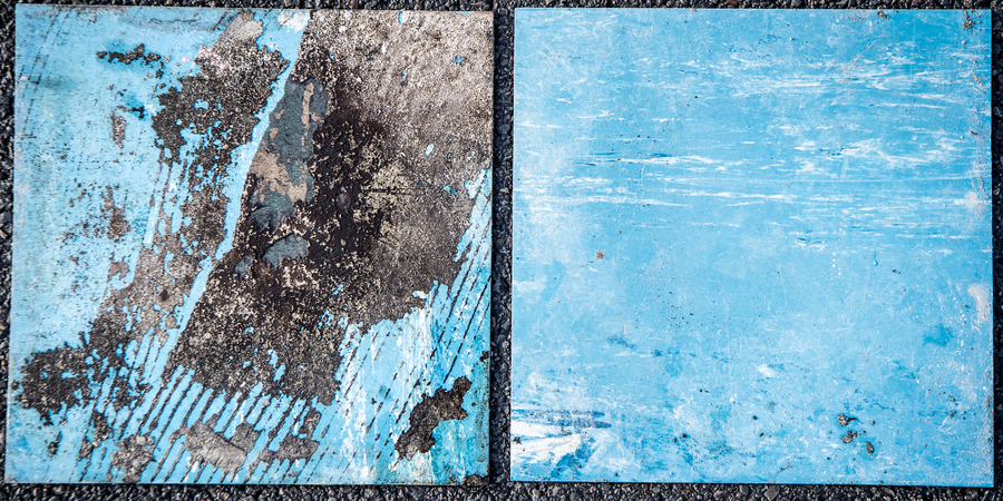 Twee oude blauwe vloertegels die niet-gebonden asbest bevatten.
