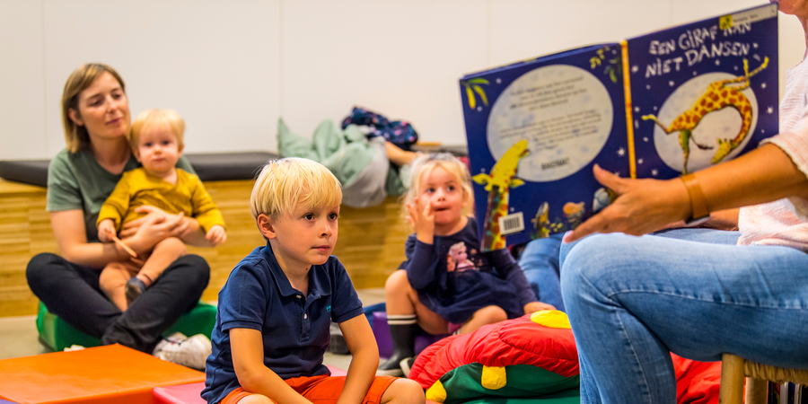 Kleuters en kleine kinderen tijdens een voorleessessie Kleuters en kleine kinderen tijdens een voorleessessie