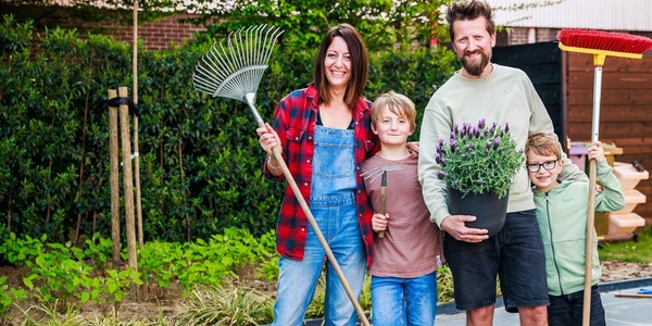 Gezin dat deelneemt aan de Lentepoets met tuingerief en een bloempot
