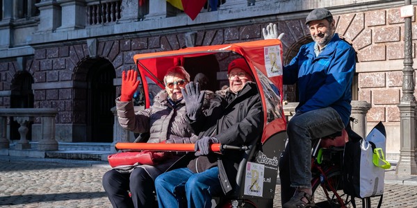 senioren zitten in een fietstaxi