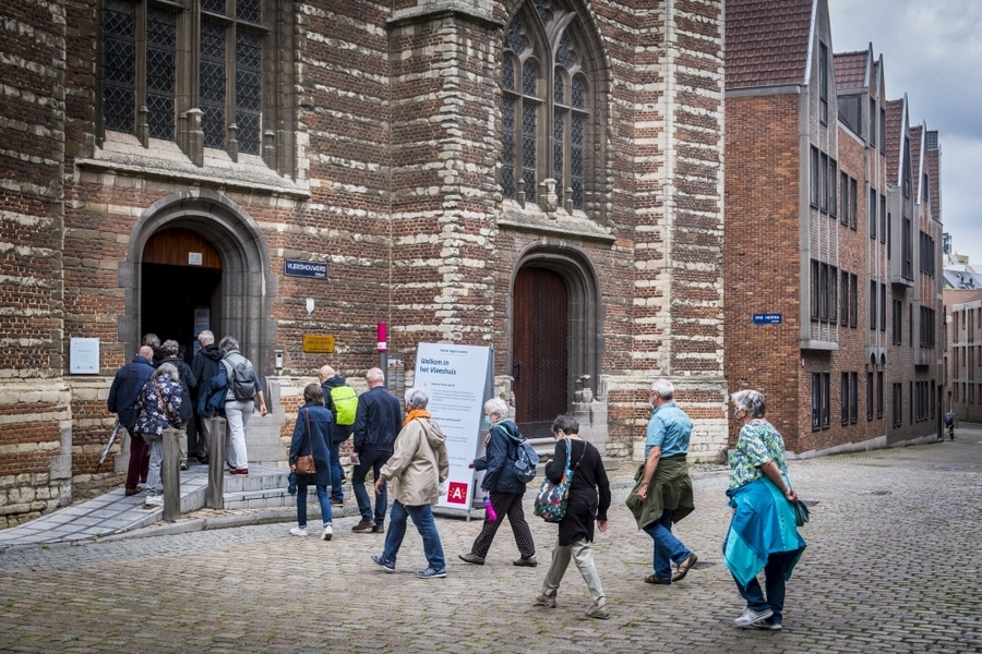 Groep mensen gaat het Vleeshuis binnen Groep mensen gaat het Vleeshuis binnen