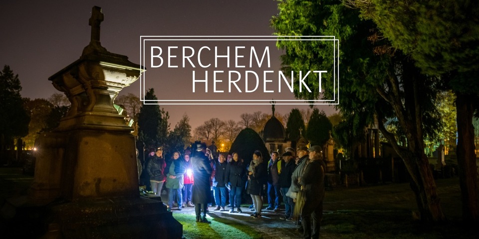 Groep mensen die tijdens een avondwandeling op het Floraliënhof naar een gids luisteren