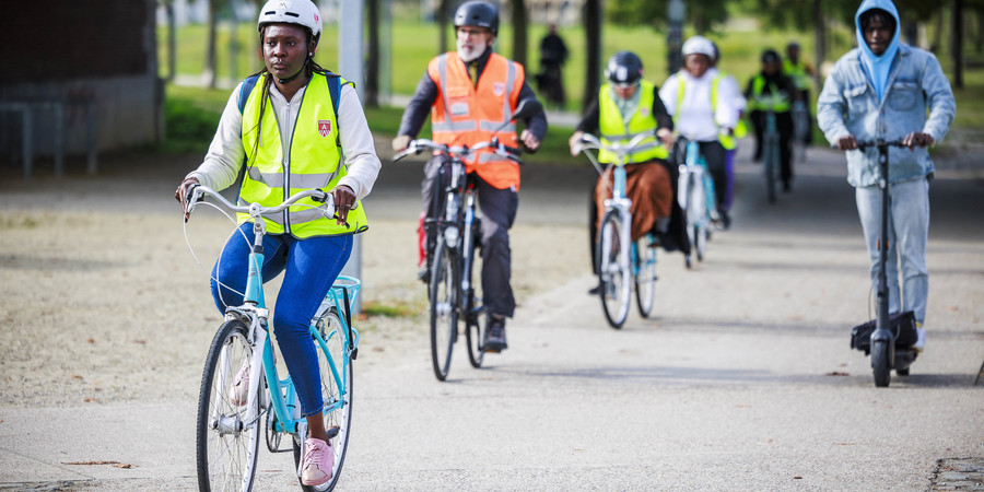 Vrouw op fiets die in Park Spoor Noord leert fietsen