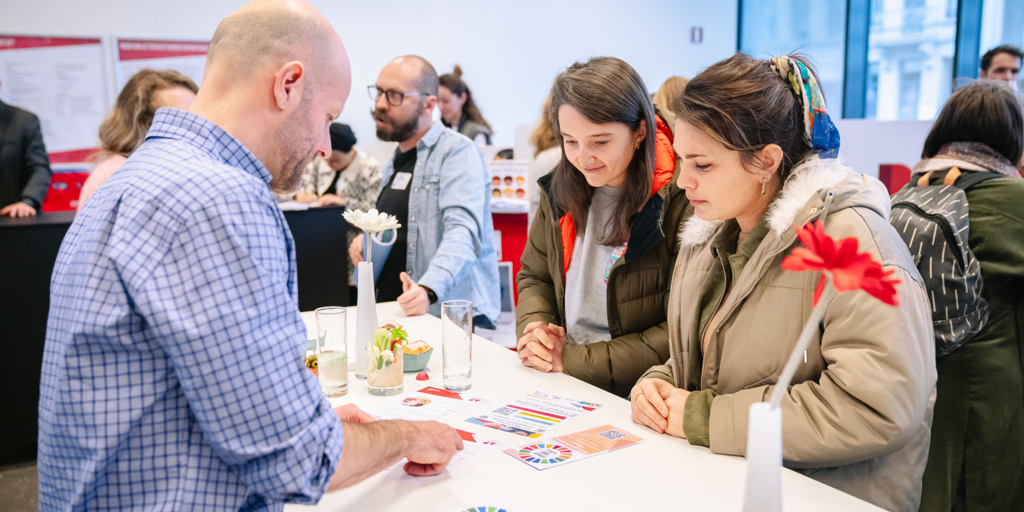 Mensen krijgen info aan een infostand